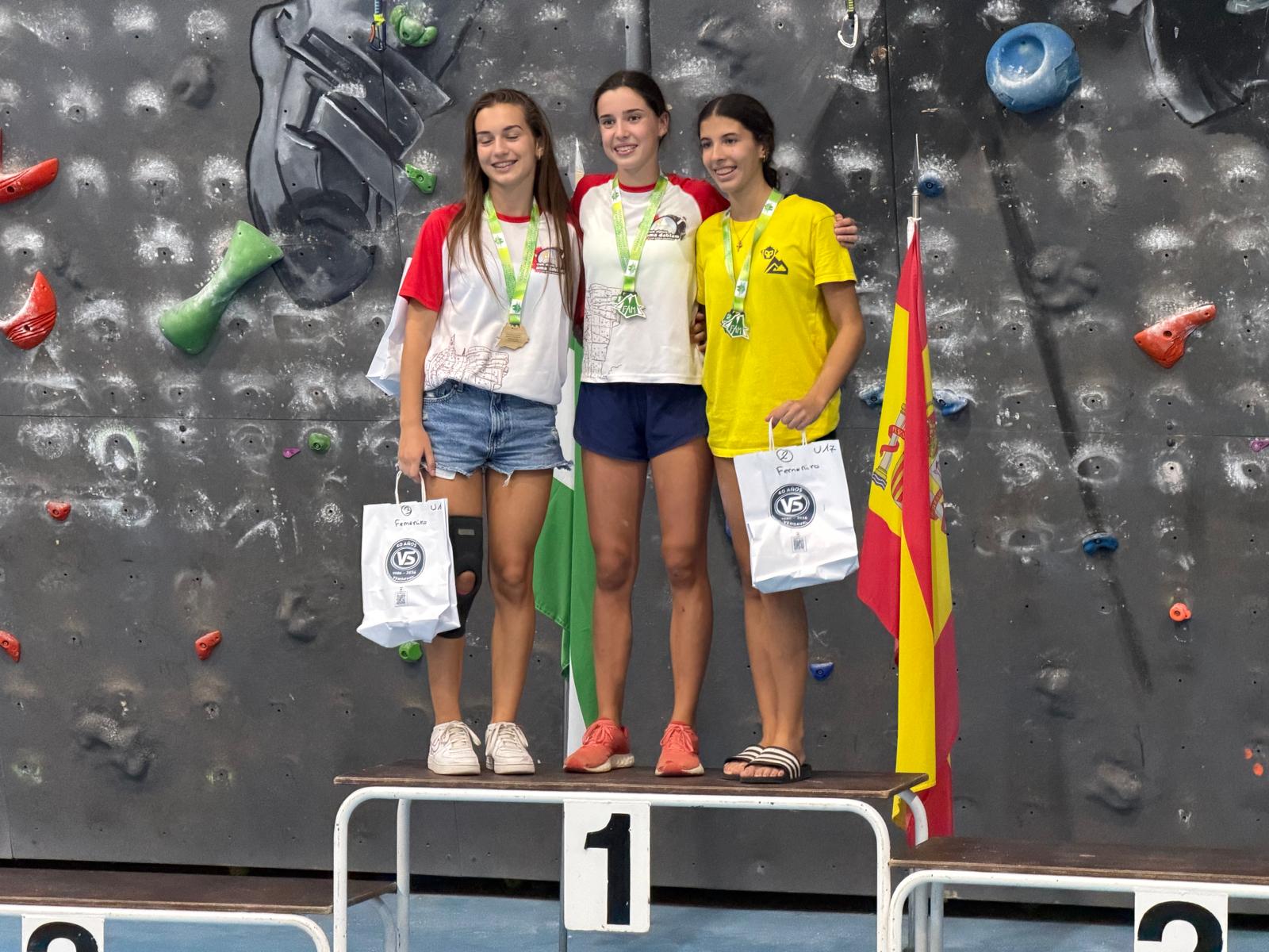 Podio sub-17 femenino en Manilva: Candela, del club, en lo más alto con su medalla de oro, y a su lado Sofía, también del club, con el bronce